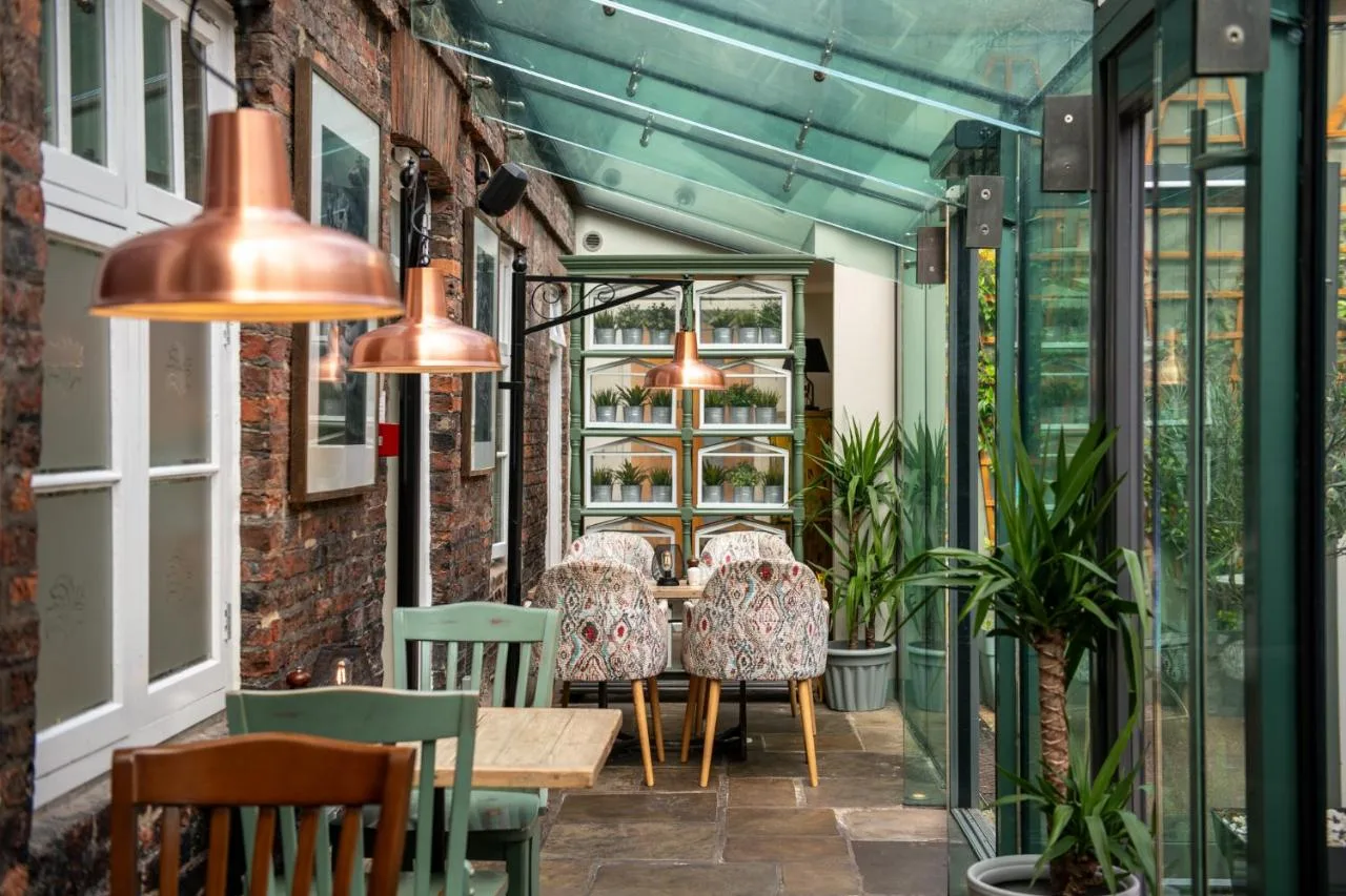 A patio with a table, chairs and lights at Judge's Lodging in York